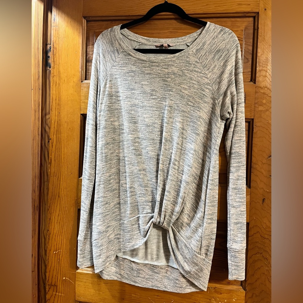 Woman’s large sweater. Pink and gray in color